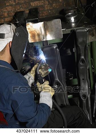 Close-up of a welder welding in a workshop View Large Photo Image Stock Image - Close-up of a welder welding in a workshop. Fotosearch