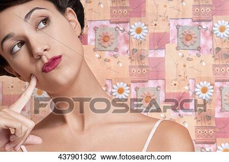 Stock Image - Close-up of a woman day dreaming. Fotosearch