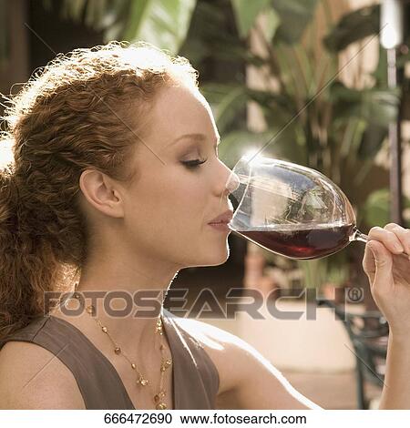 Stock Image - Close-up of a woman drinking red wine, Biltmore Hotel, Coral Gables, Florida, USA. Fotosearch