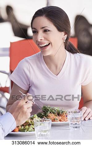Close-up of a woman eating salad in a restaurant View Large Photo Image Picture - Close-up of a woman eating salad in a restaurant. Fotosearch