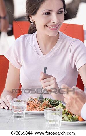 Close-up of a woman eating salad in a restaurant View Large Photo Image Picture - Close-up of a woman eating salad in a restaurant. Fotosearch
