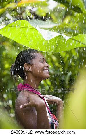 Close-up of a woman enjoying rain shower View Large Photo Image Stock Image - Close-up of a woman enjoying rain shower. Fotosearch