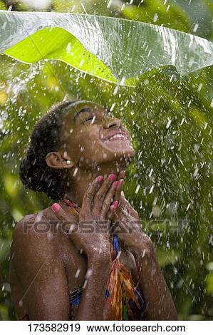 Close-up of a woman enjoying rain shower View Large Photo Image Stock Photo - Close-up of a woman enjoying rain shower. Fotosearch