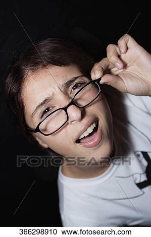 Close-up of a woman holding eyeglasses and smiling View Large Photo Image Stock Image - Close-up of a woman holding eyeglasses and smiling. Fotosearch