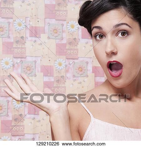 Close-up of a woman looking surprised View Large Photo Image Stock Photograph - Close-up of a woman looking surprised. Fotosearch