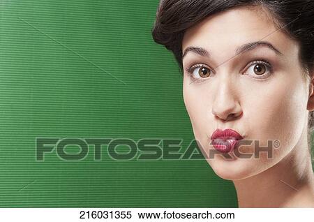 Stock Photography - Close-up of a woman puckering her lips. Fotosearch