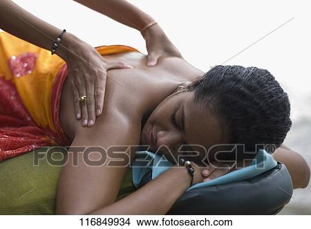 Close-up of a woman receiving a back massage View Large Photo Image Picture - Close-up of a woman receiving a back massage. Fotosearch