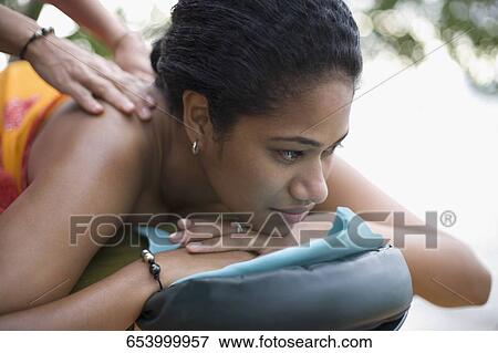 Close-up of a woman receiving a back massage View Large Photo Image Stock Photo - Close-up of a woman receiving a back massage. Fotosearch