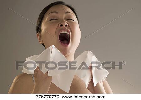 Close-up of a woman sneezing View Large Photo Image Stock Image - Close-up of a woman sneezing. Fotosearch