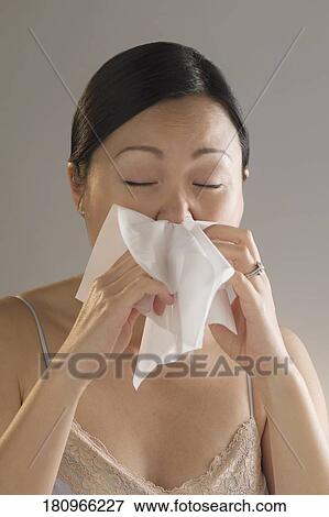 Stock Photo - Close-up of a woman sneezing. Fotosearch