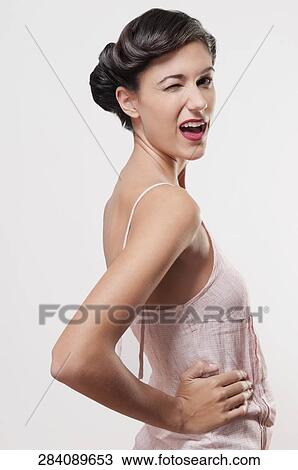 Close-up of a woman winking View Large Photo Image Stock Image - Close-up of a woman winking. Fotosearch