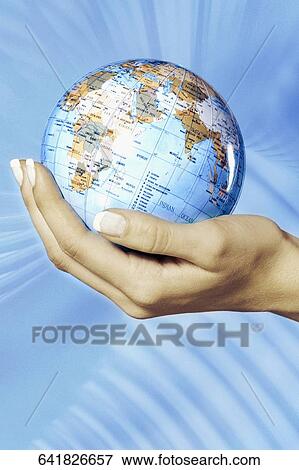 Close-up of a woman's hand holding a globe View Large Photo Image Stock Photo - Close-up of a woman's hand holding a globe. Fotosearch