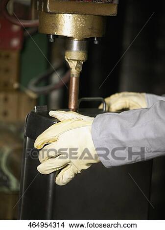 Close-up of a worker working on a spot welding machine View Large Photo Image Picture - Close-up of a worker working on a spot welding machine. Fotosearch