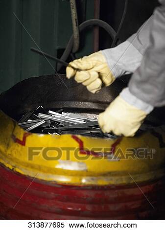 Close-up of a worker's hand near a container View Large Photo Image Stock Photography - Close-up of a worker's hand near a container. Fotosearch