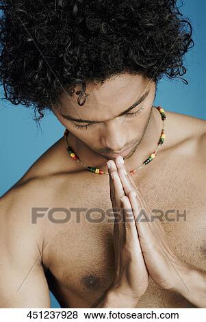 Close-up of a young man in a prayer position View Large Photo Image Stock Photo - Close-up of a young man in a prayer position. Fotosearch