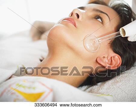 Close-up of a young woman getting a face massage View Large Photo Image Picture - Close-up of a young woman getting a face massage. Fotosearch