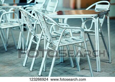 Close-up of an empty table and chairs in a sidewalk cafe View Large Photo Image Picture - Close-up of an empty table and chairs in a sidewalk cafe. Fotosearch