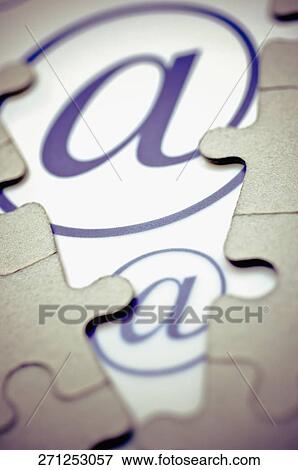 Close-up of at symbol between jigsaw pieces View Large Photo Image Stock Photo - Close-up of at symbol between jigsaw pieces. Fotosearch
