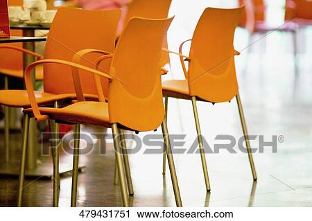 Stock Image - Close-up of chairs in a restaurant. Fotosearch