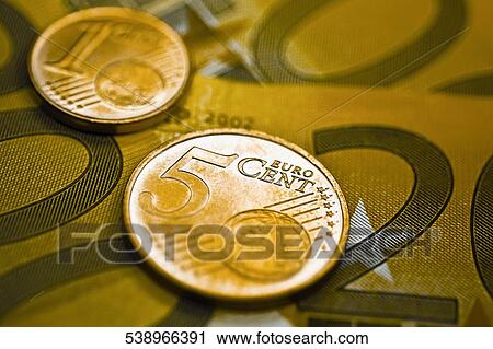Stock Image - Close-up of European union coins on banknotes. Fotosearch