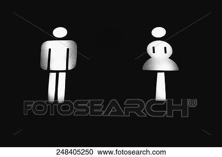 Stock Image - Close-up of illuminated male and female toilet signs in an airplane. Fotosearch