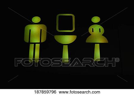 Close-up of illuminated male and female toilet signs in an airplane View Large Photo Image Stock Photograph - Close-up of illuminated male and female toilet signs in an airplane. Fotosearch