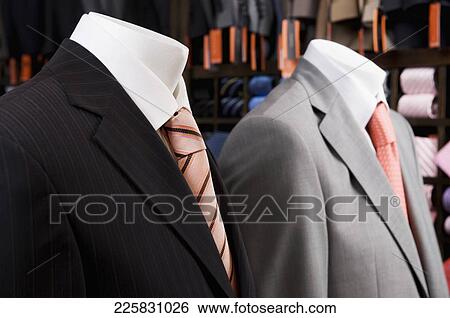 Stock Photograph - Close-up of mannequins with formal suits in a clothing store. Fotosearch