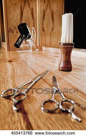 Stock Photograph - Close-up of scissors with a hair dryer and a shaving brush. Fotosearch