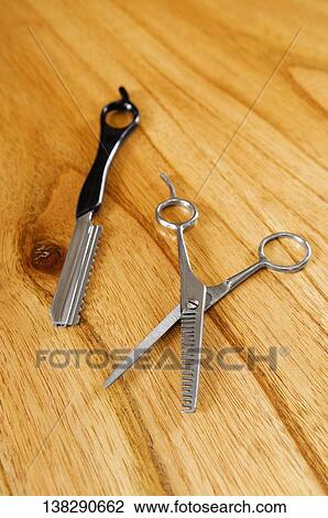 Close-up of scissors with a razor View Large Photo Image Stock Image - Close-up of scissors with a razor. Fotosearch