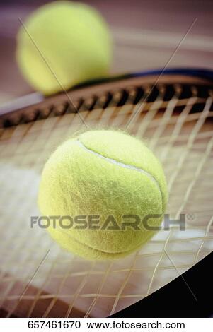 Close-up of tennis balls and a tennis racket View Large Photo Image Stock Image - Close-up of tennis balls and a tennis racket. Fotosearch