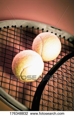 Stock Image - Close-up of tennis balls and tennis rackets. Fotosearch