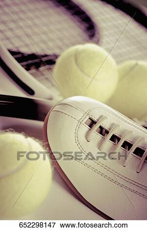 Stock Photo - Close-up of tennis rackets with tennis balls and a sports shoe. Fotosearch