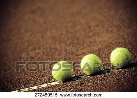 Stock Photography - Close-up of three tennis balls in a court. Fotosearch