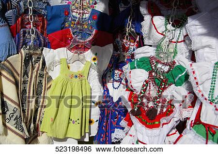 Stock Photograph - Close-up of traditional Mexican dresses at a market stall, Olvera Street, Los Angeles, California, USA. Fotosearch