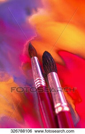 Close-up of two paintbrushes on a painting View Large Photo Image Stock Photograph - Close-up of two paintbrushes on a painting. Fotosearch