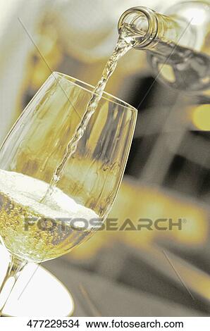 Close-up of wine being poured into a wine glass View Large Photo Image Picture - Close-up of wine being poured into a wine glass. Fotosearch