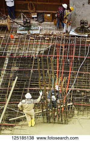 Stock Photo - Construction workers working at a construction site. Fotosearch