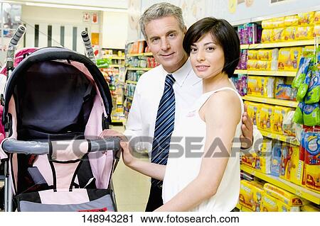 Couple buying a baby stroller in a supermarket View Large Photo Image Stock Image - Couple buying a baby stroller in a supermarket. Fotosearch