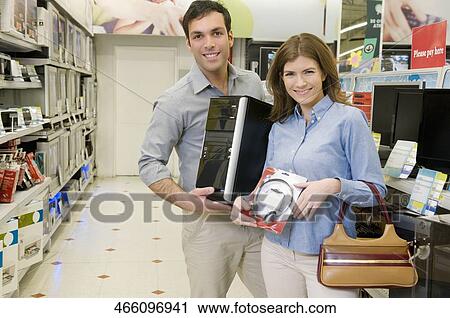 Couple buying CPU and headphones in a supermarket View Large Photo Image Stock Image - Couple buying CPU and headphones in a supermarket. Fotosearch