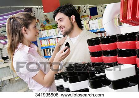 Couple buying crockery in a supermarket View Large Photo Image Stock Photograph - Couple buying crockery in a supermarket. Fotosearch