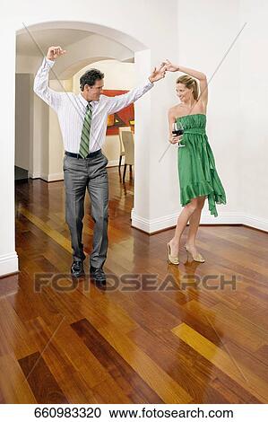 Couple celebrating in a house View Large Photo Image Stock Image - Couple celebrating in a house. Fotosearch