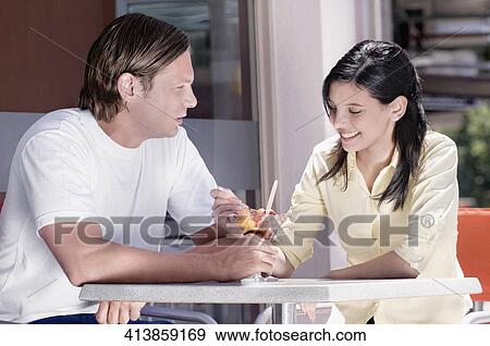 Couple eating ice cream View Large Photo Image Stock Photo - Couple eating ice cream. Fotosearch