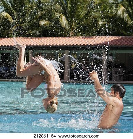 Couple having fun in a swimming pool, Biltmore Hotel, Coral Gables, Florida, USA View Large Photo Image Picture - Couple having fun in a swimming pool, Biltmore Hotel, Coral Gables, Florida, USA. Fotosearch