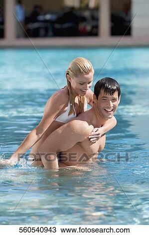 Stock Image - Couple having fun in a swimming pool, Biltmore Hotel, Coral Gables, Florida, USA. Fotosearch