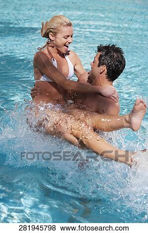 Stock Photo - Couple having fun in a swimming pool, Biltmore Hotel, Coral Gables, Florida, USA. Fotosearch