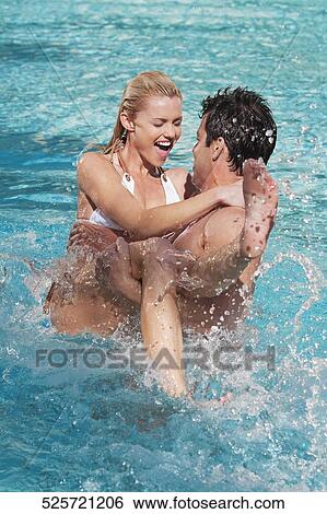 Stock Photograph - Couple having fun in a swimming pool, Biltmore Hotel, Coral Gables, Florida, USA. Fotosearch