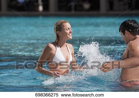 Stock Photography - Couple having fun in a swimming pool, Biltmore Hotel, Coral Gables, Florida, USA. Fotosearch