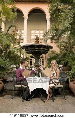 Couple holding menu cards and toasting with wine, Biltmore Hotel, Coral Gables, Florida, USA View Large Photo Image Stock Photo - Couple holding menu cards and toasting with wine, Biltmore Hotel, Coral Gables, Florida, USA. Fotosearch