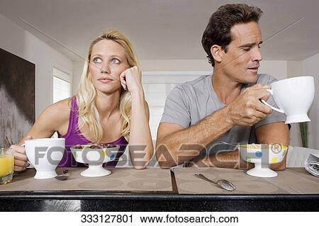 Couple ignoring each other at breakfast View Large Photo Image Stock Image - Couple ignoring each other at breakfast. Fotosearch