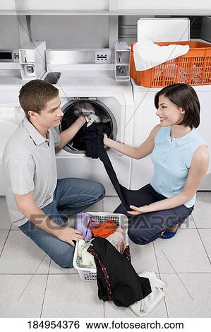 Couple in a laundromat View Large Photo Image Stock Photograph - Couple in a laundromat. Fotosearch